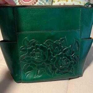 Patricia Nash Rose Tooled crossbody in a dark green color. New without tags